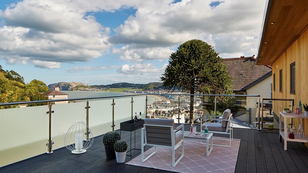 Garden room patio area with composite deck and stylish outdoor furniture