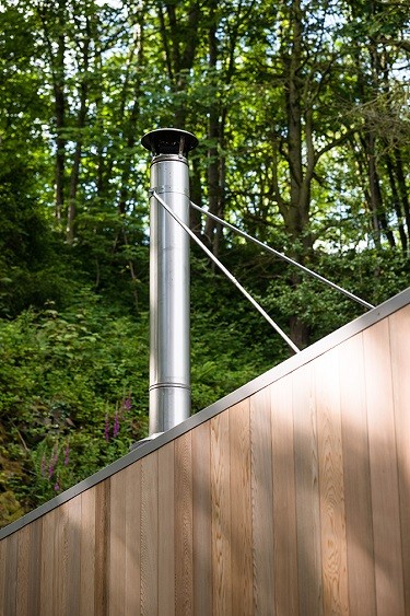 Garden studio cladded in Western Red Cedar inclusive of a wood burner