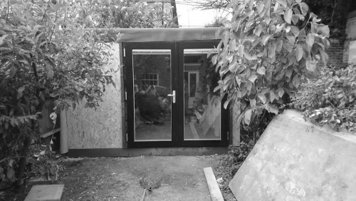 Outdoor office with cedar cladding and cement boards